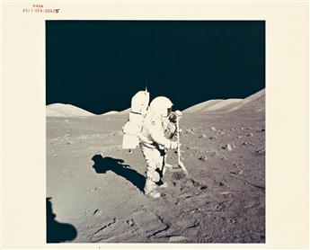 (NASA) Group of 24 color photographs, including the iconic image by Neil Armstrong of Buzz Aldrin walking on the moon, the Earthrise, a